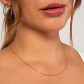 14k Yellow Gold Paper Clip Chain with Lobster Lock on woman's neck